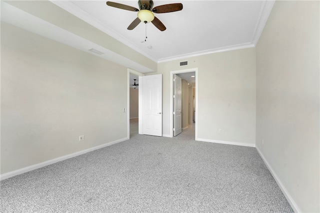 spare room featuring carpet floors, ceiling fan, and crown molding