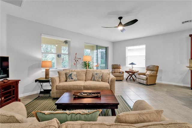 living room featuring light tile patterned floors and ceiling fan