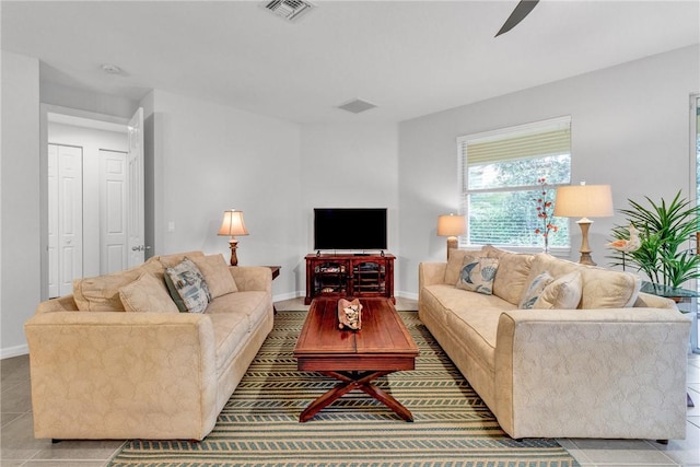 living room with light tile patterned floors and ceiling fan