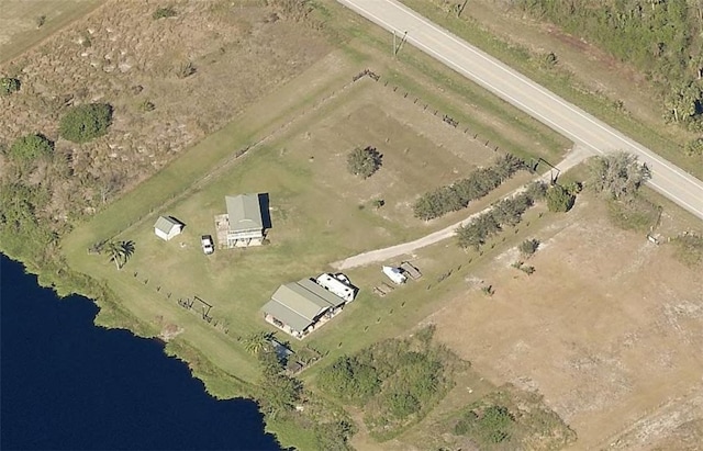 birds eye view of property with a water view and a rural view