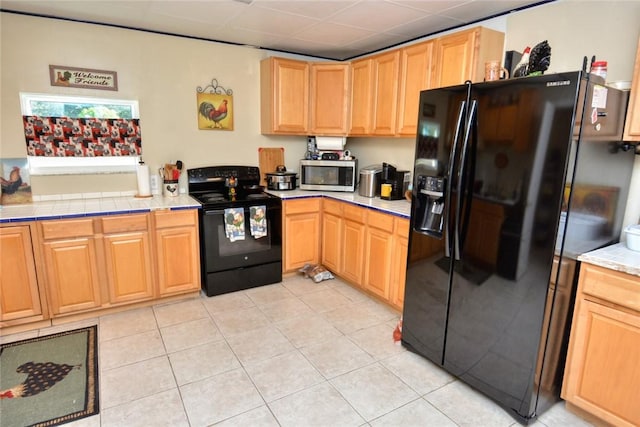 kitchen with light tile patterned floors and black appliances