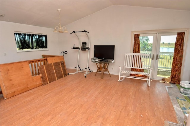 interior space with hardwood / wood-style floors, an inviting chandelier, french doors, and lofted ceiling