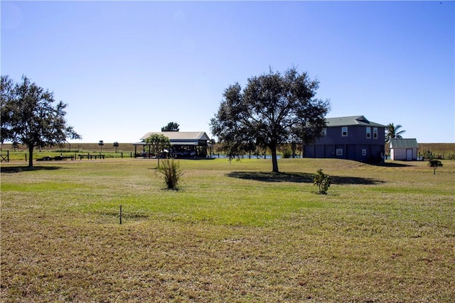 back of property featuring a lawn and a water view