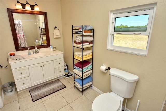 bathroom with tile patterned flooring, vanity, toilet, and walk in shower