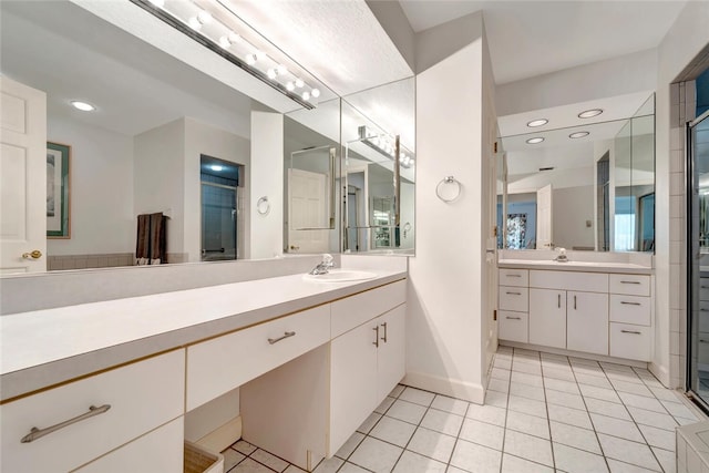 202 N Carmel Ct, Vero Beach, FL 32963 - bathroom with tile patterned floors, baseboards, a stall shower, and a sink