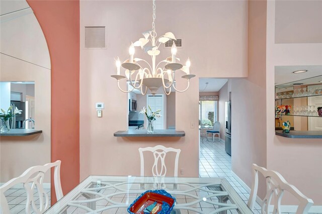 202 N Carmel Ct, Vero Beach, FL 32963 - dining room with tile patterned flooring, an inviting chandelier, and visible vents