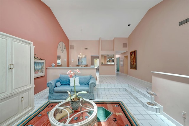 202 N Carmel Ct, Vero Beach, FL 32963 - living room with light tile patterned floors, an inviting chandelier, high vaulted ceiling, and visible vents