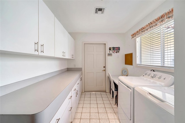 202 N Carmel Ct, Vero Beach, FL 32963 - laundry room with visible vents, light tile patterned floors, cabinet space, and washing machine and clothes dryer
