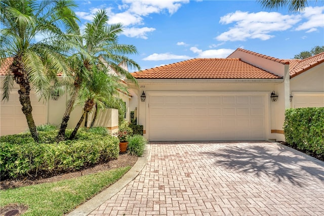 202 N Carmel Ct, Vero Beach, FL 32963 - mediterranean / spanish home with a tile roof, decorative driveway, stucco siding, and a garage