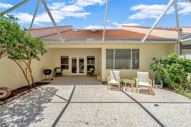 202 N Carmel Ct, Vero Beach, FL 32963 - rear view of property featuring a tiled roof, stucco siding, french doors, and a patio area
