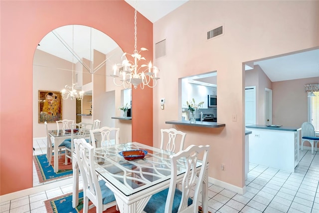 202 N Carmel Ct, Vero Beach, FL 32963 - tiled dining area featuring a chandelier, visible vents, baseboards, and high vaulted ceiling