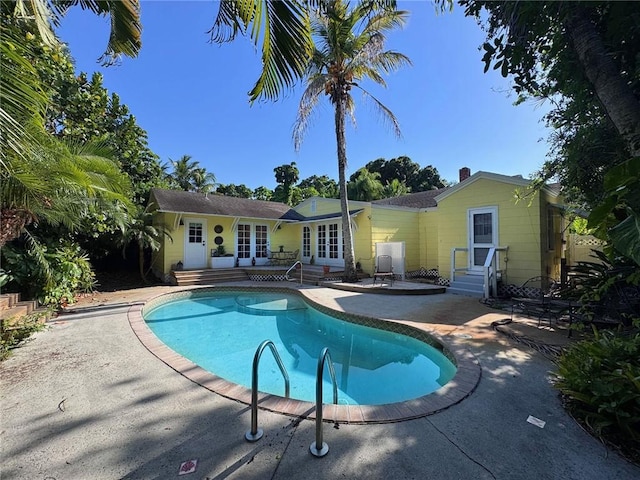 2434 19th Ave, Vero Beach, FL 32960 - swimming pool featuring a patio, french doors, and entry steps