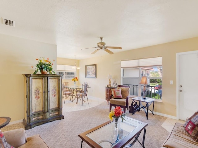 tiled living room featuring ceiling fan