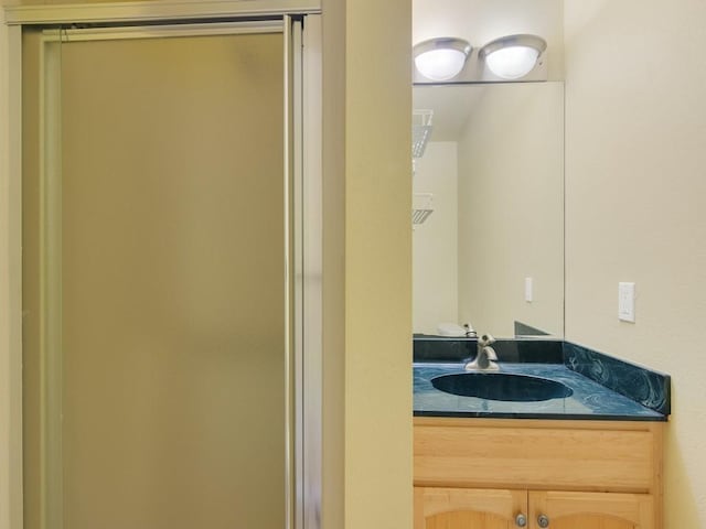 bathroom featuring vanity and an enclosed shower