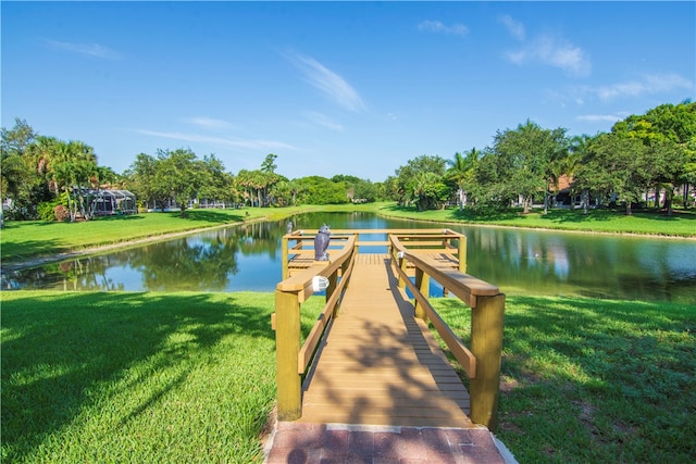 dock area featuring a yard and a water view