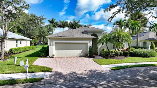 view of front of house with a garage and a front yard