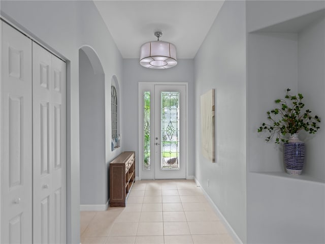 doorway with light tile patterned floors