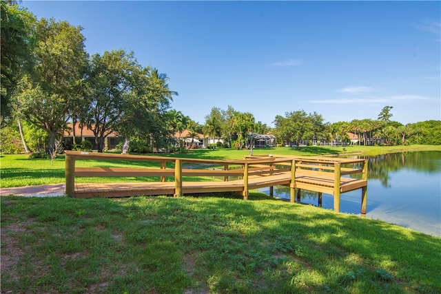 dock area featuring a gazebo, a yard, and a water view