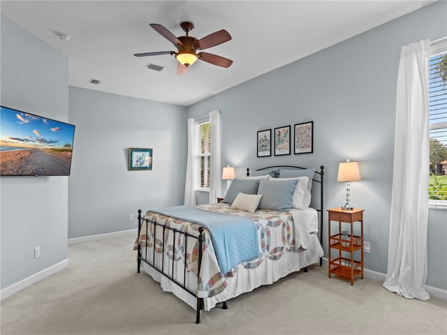 bedroom with light carpet and ceiling fan