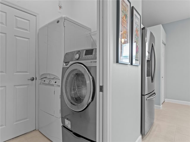 washroom with washing machine and clothes dryer and light tile patterned floors