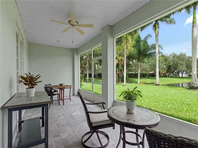 sunroom featuring ceiling fan