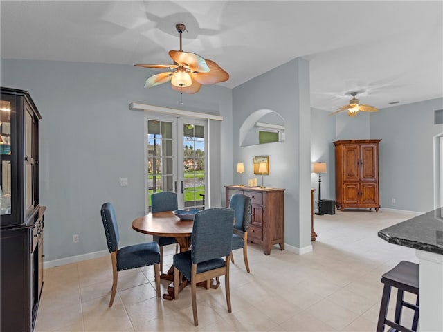 dining area featuring light tile patterned flooring, vaulted ceiling, ceiling fan, and french doors