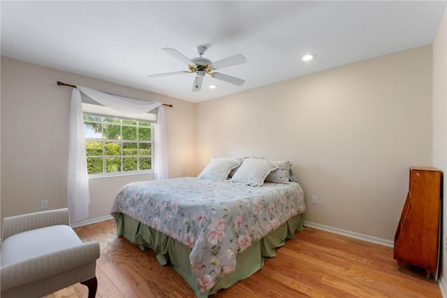 bedroom with baseboards, light wood finished floors, a ceiling fan, and recessed lighting