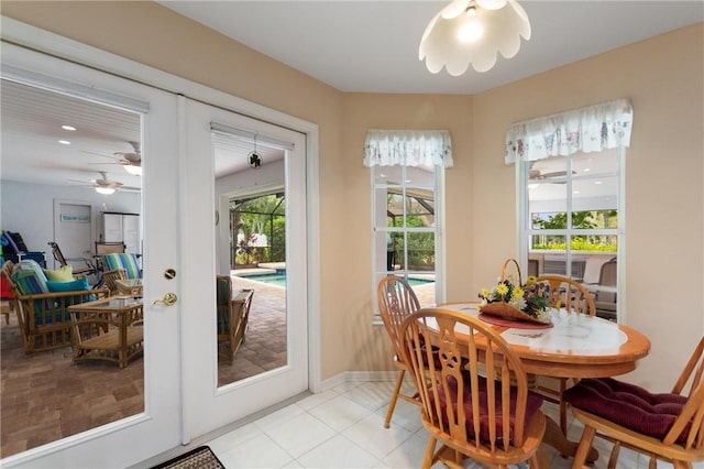 dining room featuring a ceiling fan, french doors, and baseboards
