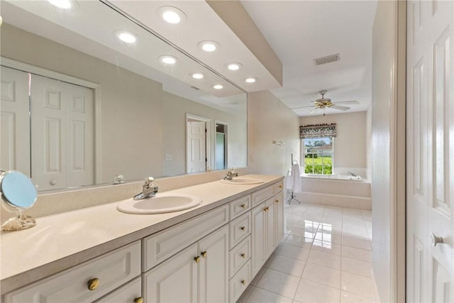 bathroom with tile patterned floors, double vanity, a garden tub, recessed lighting, and ceiling fan