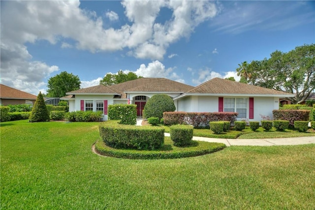 ranch-style house with a front lawn and stucco siding