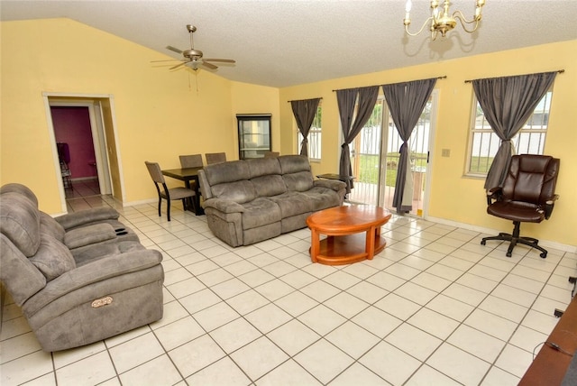 living room with lofted ceiling, a textured ceiling, light tile patterned floors, and ceiling fan with notable chandelier