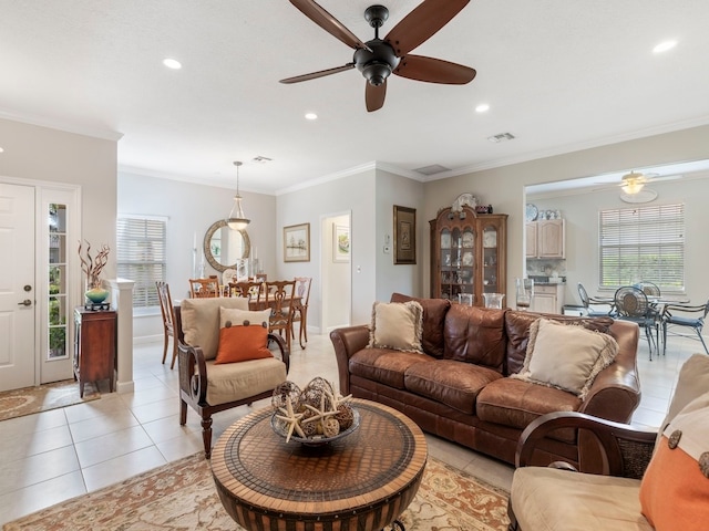 living room featuring ceiling fan, ornamental molding, and light tile patterned floors