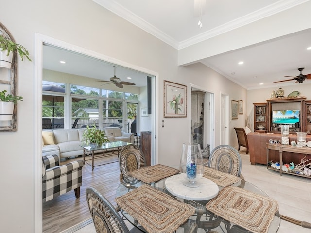 dining area featuring ceiling fan, crown molding, and light hardwood / wood-style flooring