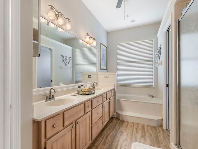 bathroom featuring a tub, ceiling fan, vanity, and hardwood / wood-style flooring