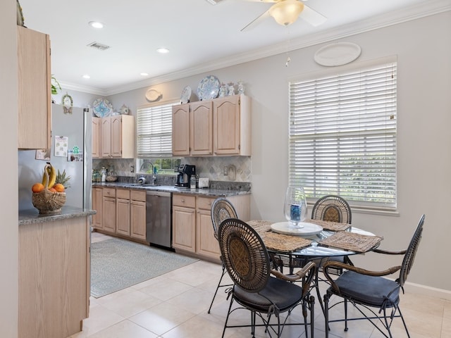 kitchen featuring light brown cabinets, tasteful backsplash, stainless steel dishwasher, crown molding, and light tile patterned flooring