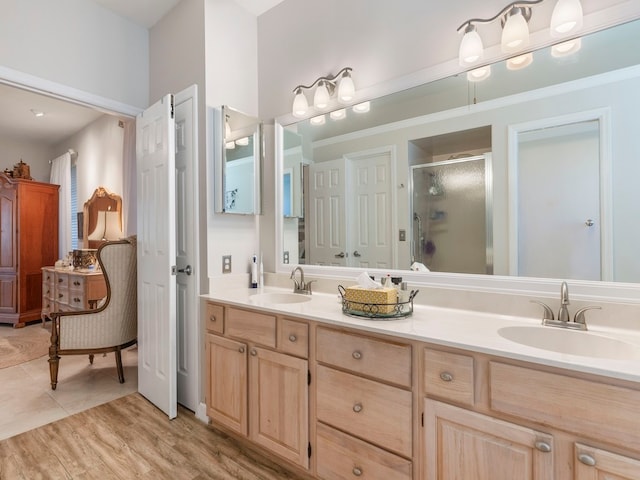 bathroom with vanity, wood-type flooring, and walk in shower