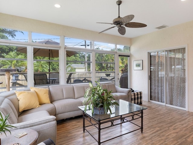 sunroom / solarium featuring ceiling fan