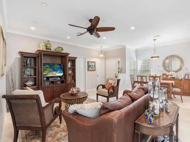 carpeted living room featuring ceiling fan and ornamental molding