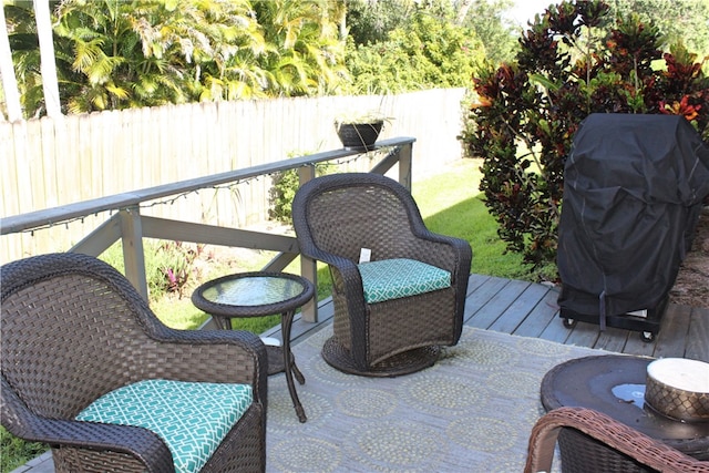 exterior space featuring a wooden deck and a grill