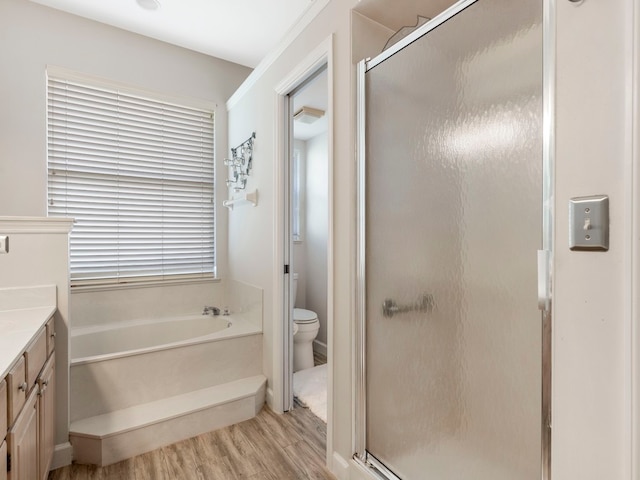 full bathroom featuring hardwood / wood-style flooring, vanity, toilet, and shower with separate bathtub