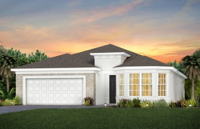 view of front of home featuring roof with shingles, stone siding, a garage, a yard, and driveway