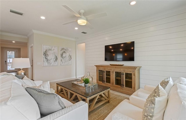 living area featuring crown molding, recessed lighting, and visible vents