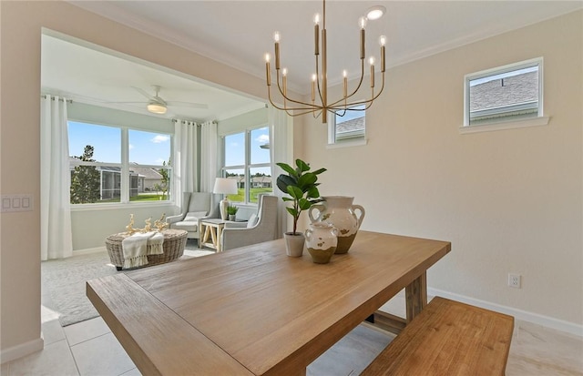 dining area featuring crown molding, baseboards, light tile patterned floors, and ceiling fan with notable chandelier
