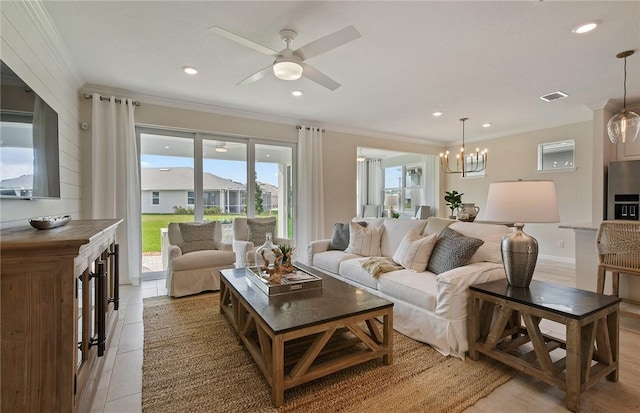 living room with crown molding, ceiling fan with notable chandelier, and a wealth of natural light