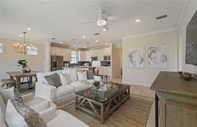 living room with recessed lighting, ornamental molding, ceiling fan with notable chandelier, and visible vents