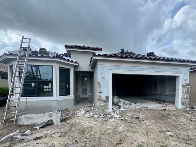 4012 Basket Oak Circle Prosperity, Vero Beach, FL 32967 - unfinished property featuring an attached garage, a tile roof, and stucco siding