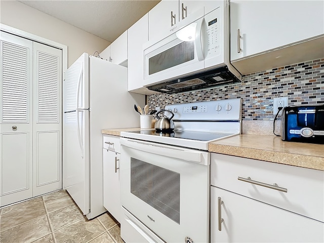 kitchen featuring white cabinets, white appliances, light tile patterned floors, and tasteful backsplash