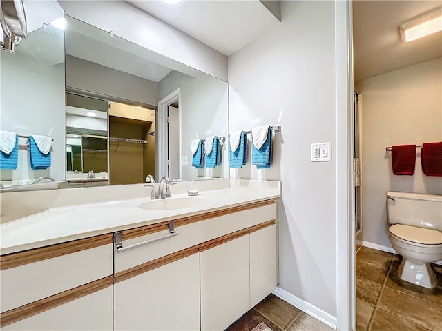 bathroom with vanity, an enclosed shower, and toilet