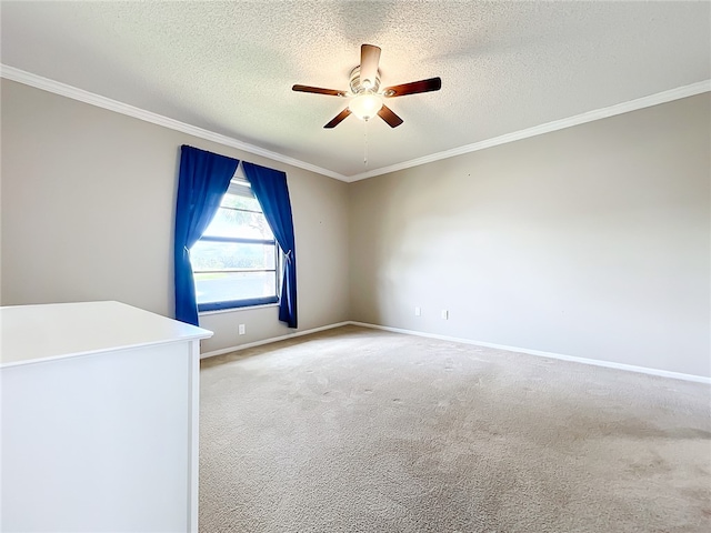 carpeted empty room featuring a textured ceiling, ceiling fan, and crown molding