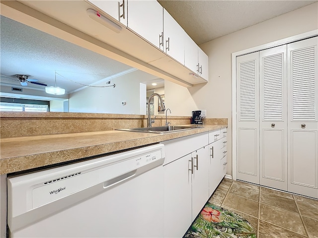 kitchen with white cabinets, a textured ceiling, white dishwasher, and sink